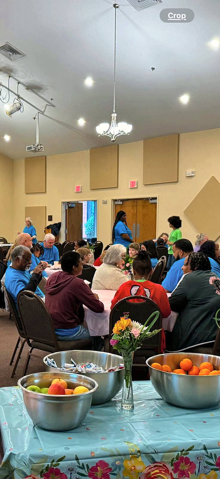 Tables of families and volunteers in the fellowship hall