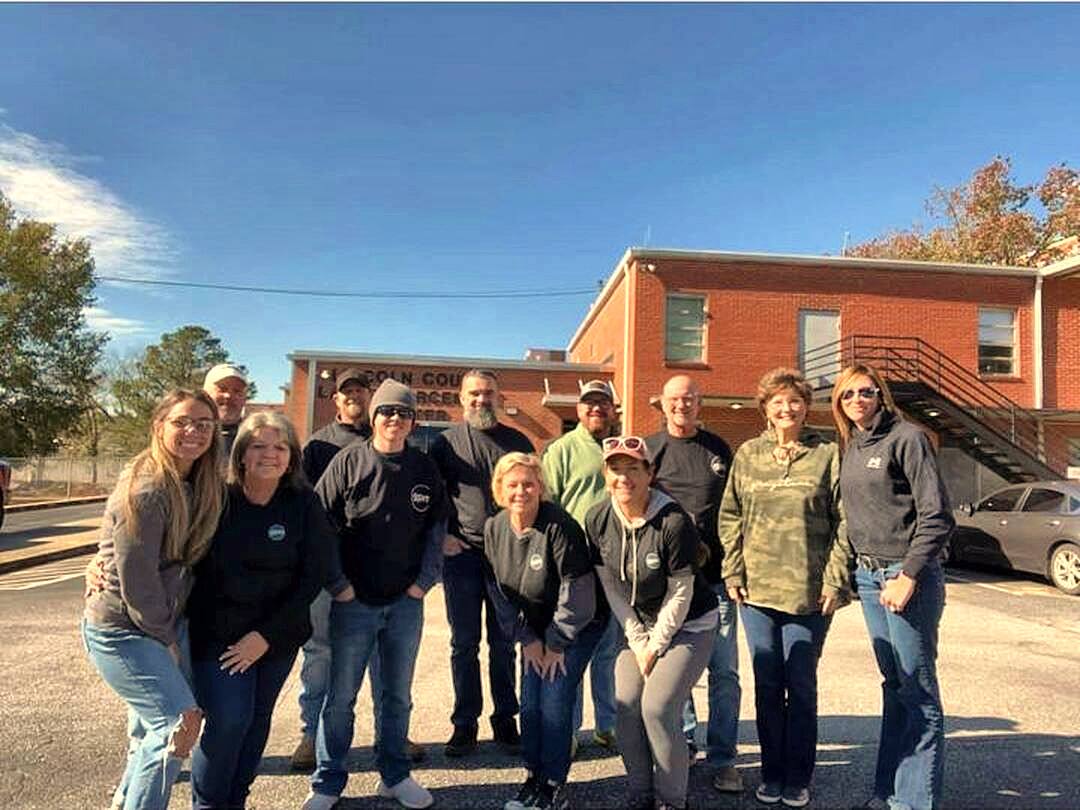 The team outside the jail on a sunny fall day
