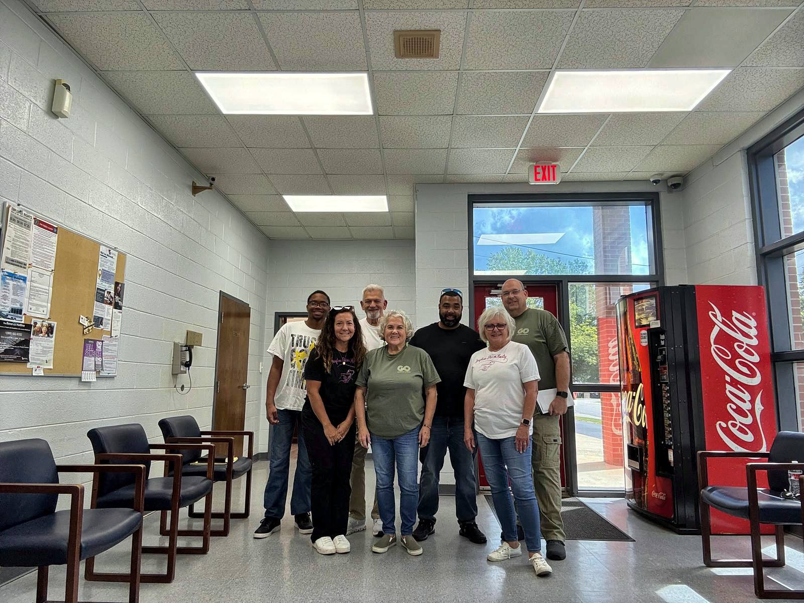 A wide view of the team in the jail lobby