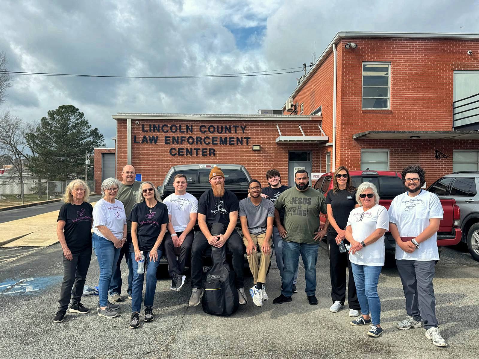 The team gathered in the parking lot outside the jail