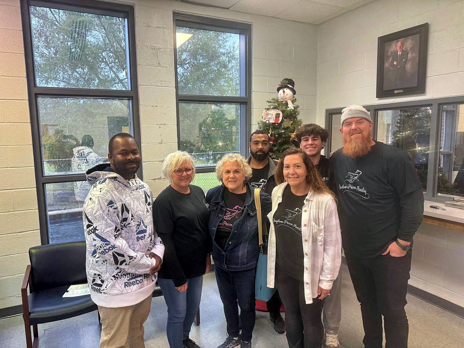 Volunteers gathered by the lobby Christmas tree