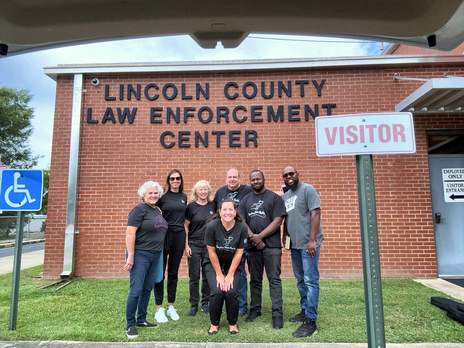 Volunteers lined up by the visitor entrance of the Lincoln County Law Enforcement Center