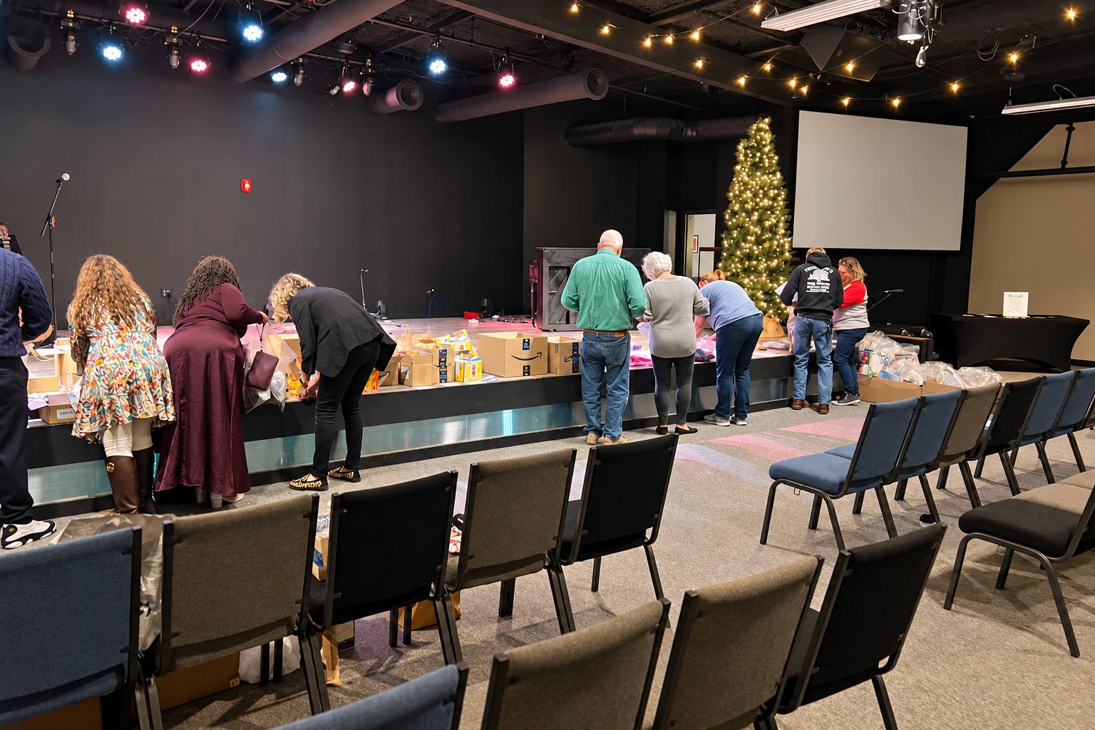 Volunteers packing care bags along the front of the Graystone stage
