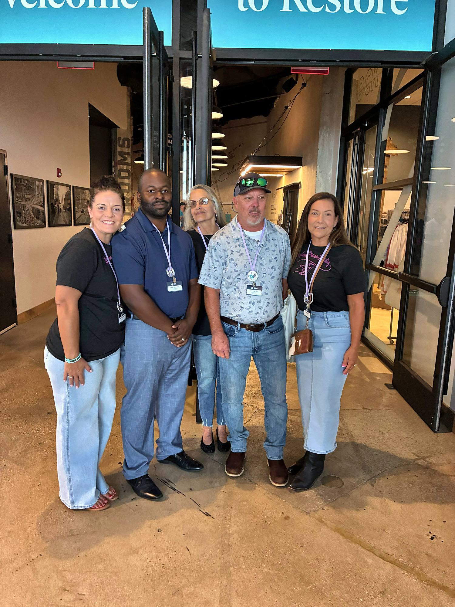 Five members of the Graystone team at the entrance to Restore 2026